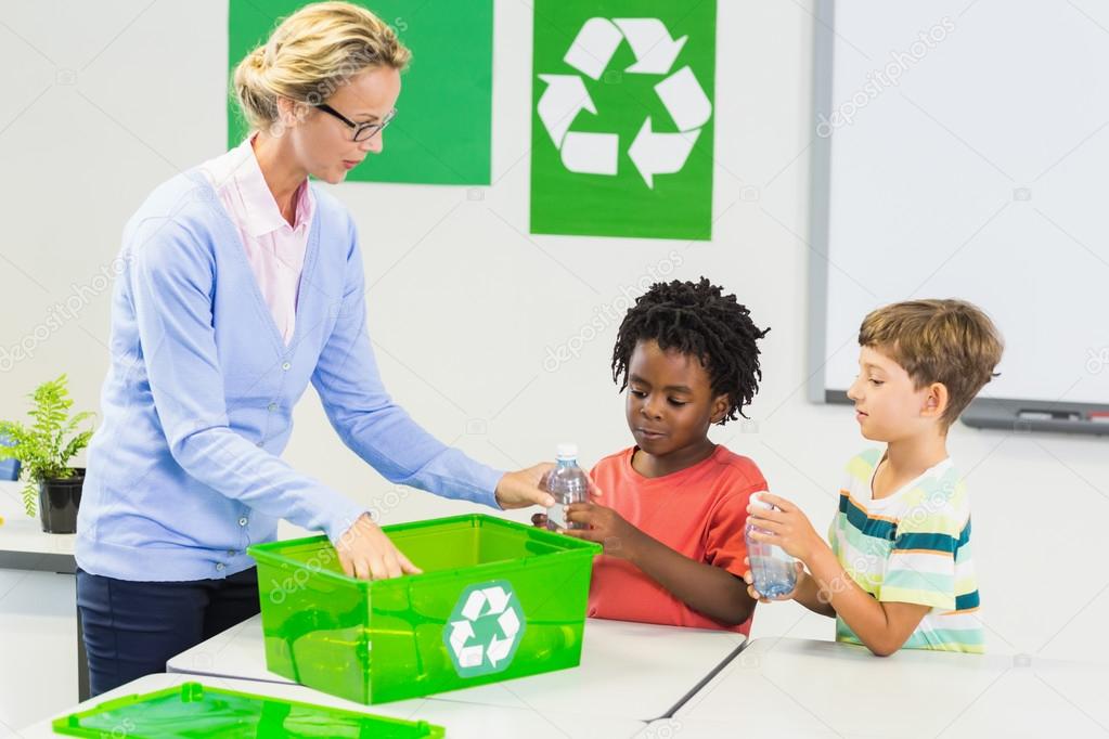 Teacher and kids discussing about recycle in classroom
