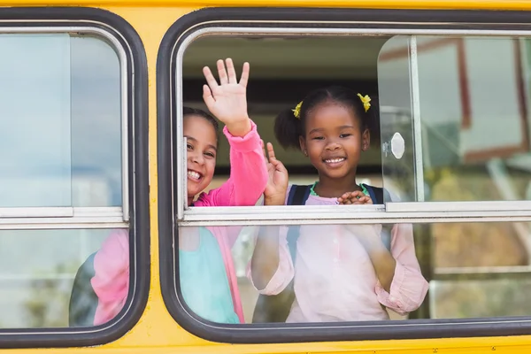 Portrait of school kids waving hand from bus — Stock Photo, Image