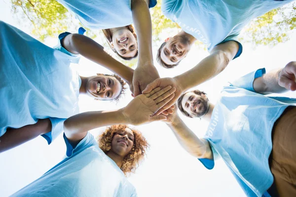 Group of volunteer forming huddles — Stock Photo, Image