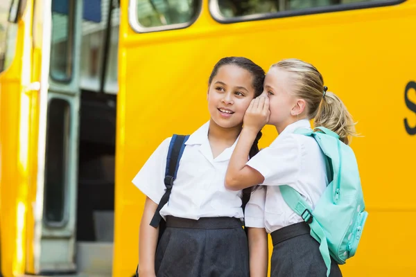 Sorridente studentessa sussurrando nell'orecchio della sua amica — Foto Stock