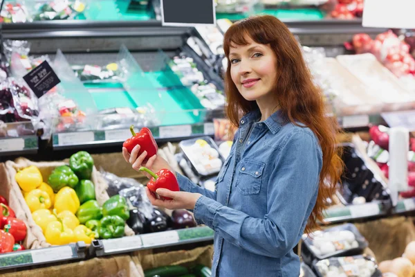 Usměvavý zákazník drží papriky — Stock fotografie