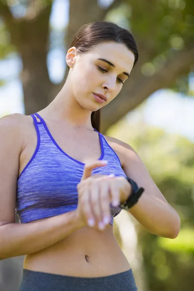 Mulher verificando o tempo durante o exercício — Fotografia de Stock