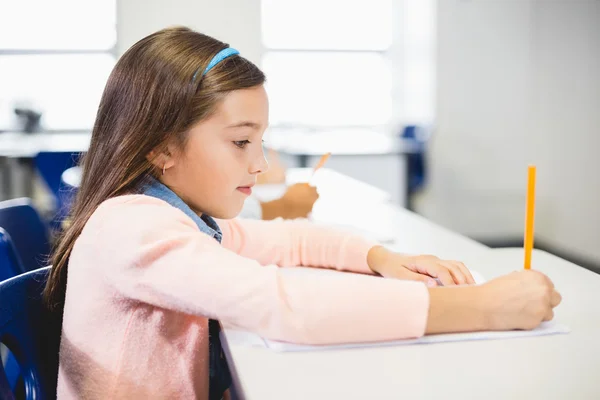 Schoolgirl studying in classroom Royalty Free Stock Images