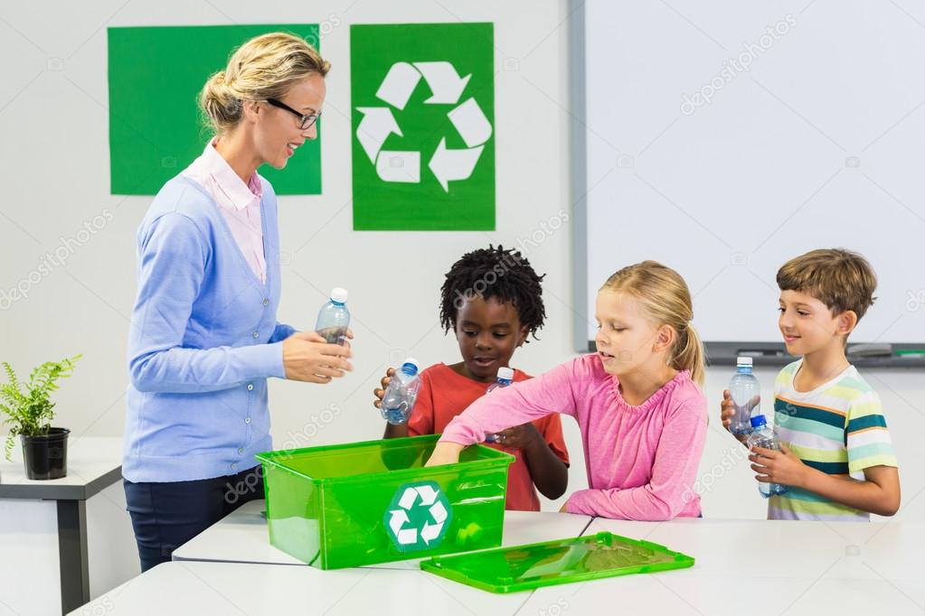 Teacher and kids discussing about recycle in classroom