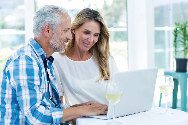 Couple looking in laptop on table — Stock Photo, Image