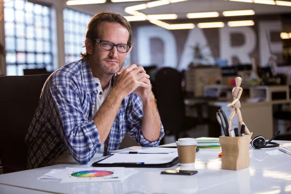 Creative businessman at desk in office — Stock Photo, Image