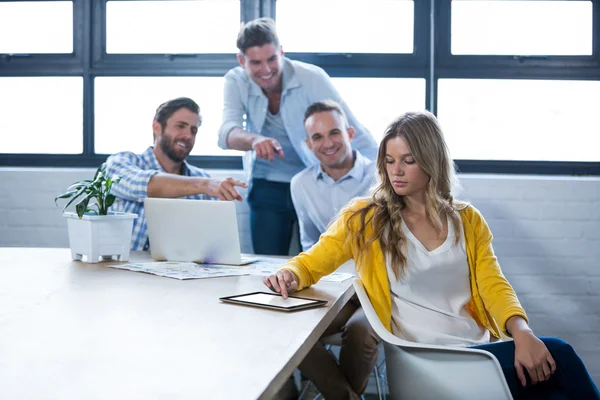 Male colleagues laughing on businesswoman — Stock Photo, Image