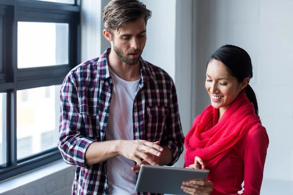 Colleagues discussing with digital tablet — Stock Photo, Image