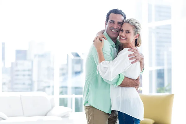 Pareja sonriente abrazándose en casa —  Fotos de Stock