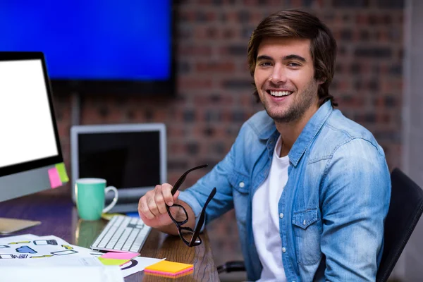 Young businessman sitting at desk — Stock Photo, Image