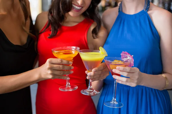 Happy female friends holding glass of cocktail — Stock Photo, Image