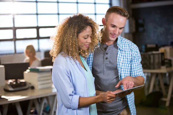 Colleagues discussing over digital tablet — Stock Photo, Image