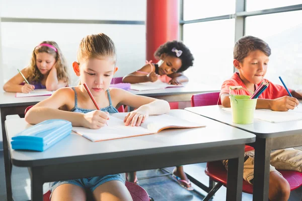 Schoolkids göra läxor i klassrummet — Stockfoto