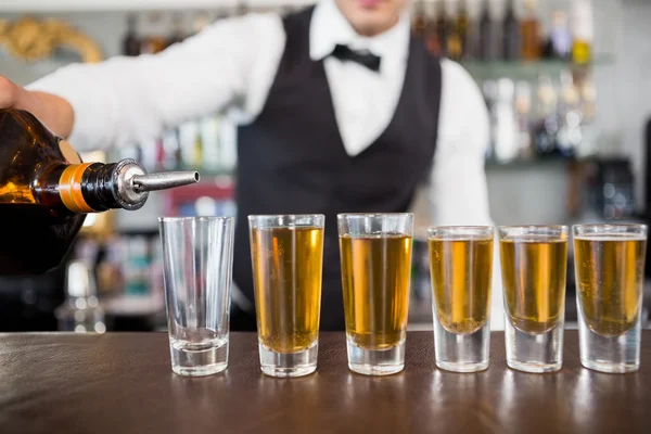 Camarero haciendo disparos en el mostrador del bar — Foto de Stock