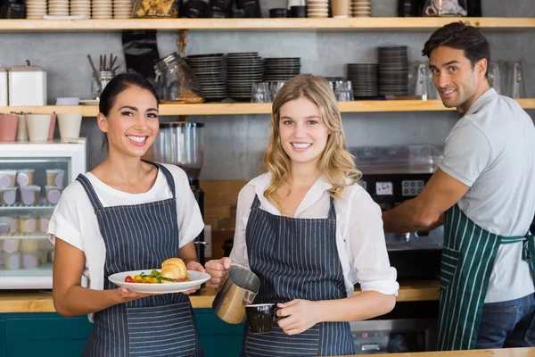 Portrait of smiling colleague working at counter — Stock Photo, Image