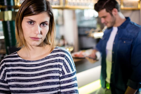 Woman with boyfriend in background — Stock Photo, Image