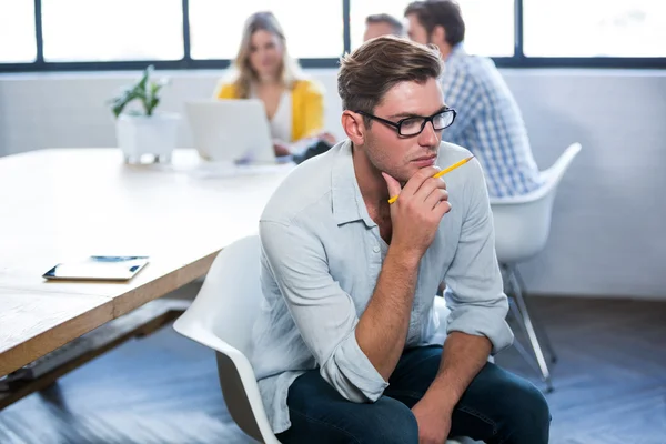 Thoughtful creative businessman in office — Stock Photo, Image