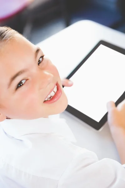 Schoolkid using digital tablet in classroom — Stock Photo, Image