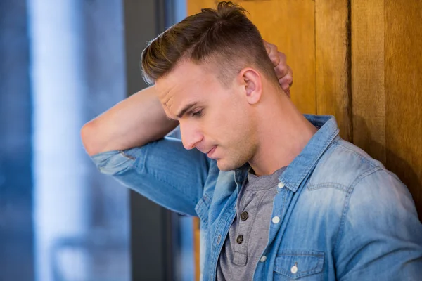 Depressed man standing by door — Stock Photo, Image