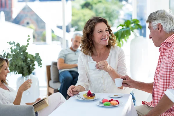 Couple smiling while having coffee — Stock Photo, Image