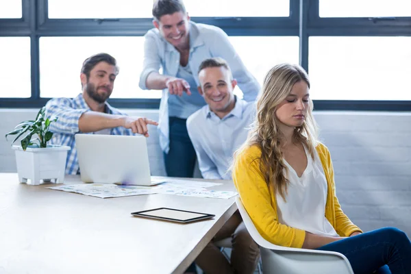 Colleagues laughing on businesswoman — Stock Photo, Image