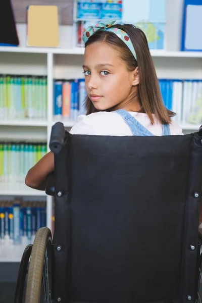 Disabled schoolgirl in library — Stock Photo, Image