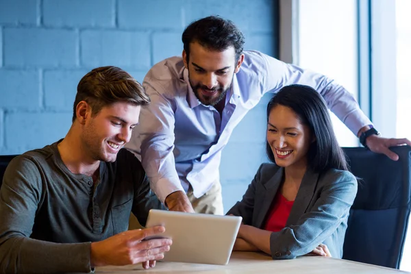 Colleagues using digital tablet in office — Stock Photo, Image