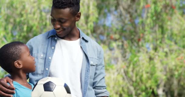 Man looking his son holding a ball — Stock Video