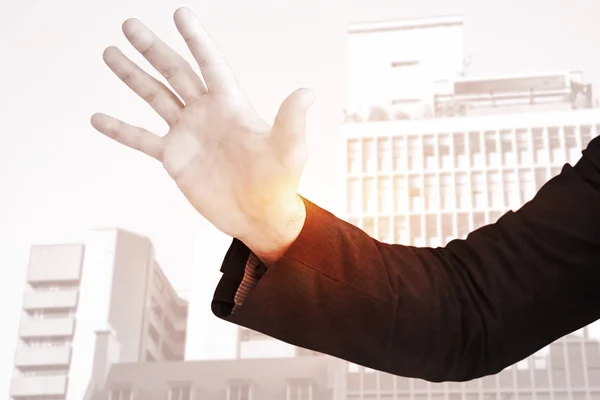 Businessman holding hand out in presentation — Stock Photo, Image