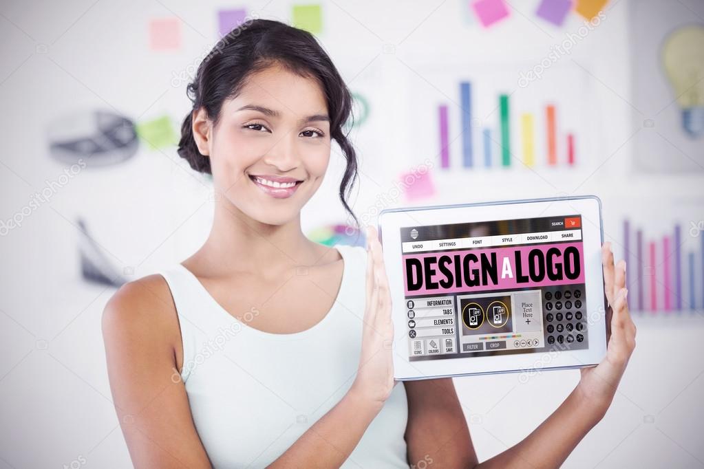 Happy businesswoman showing digital tablet in creative office against webpage for create a logo