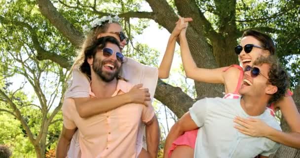 Hipster boys carrying girls on their shoulder — Stock Video