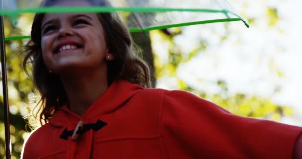 Girl smiling with umbrella — Stock Video