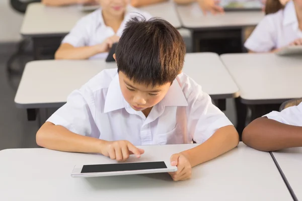 Schoolboy usando tablet digital na sala de aula — Fotografia de Stock