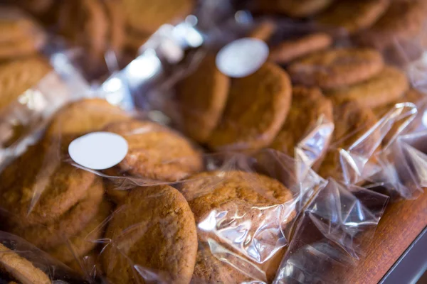 Packets of cookies on display shelf — Stock Photo, Image