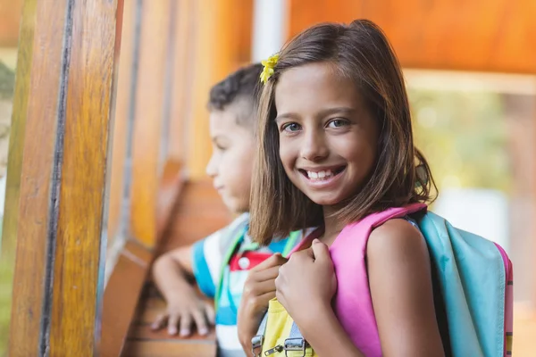Portret dziewczyny szkoły, stojący w szkolnym korytarzu — Zdjęcie stockowe