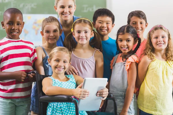 Portrait of teacher and kids in classroom — Stock Photo, Image