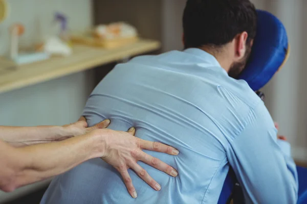 Fisioterapeuta dando masaje de espalda a un paciente — Foto de Stock