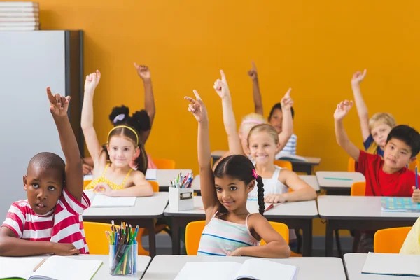 School kids raising hand in classroom — Stock Photo, Image