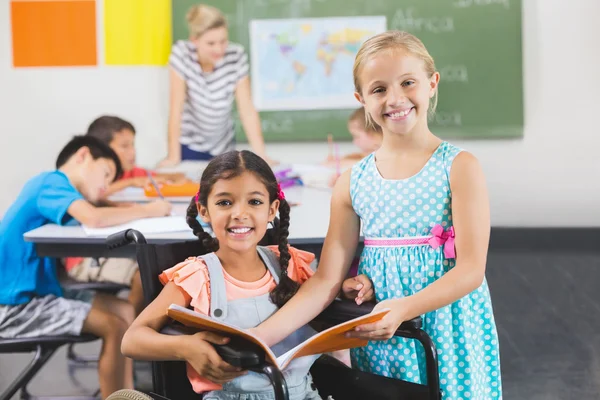 Porträt von Schulkindern mit Buch im Klassenzimmer — Stockfoto