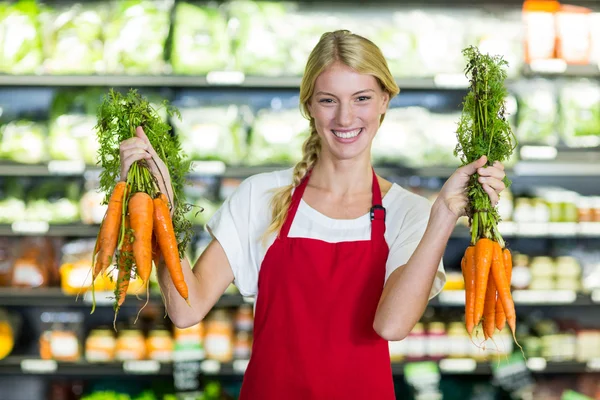 Personnel féminin souriant tenant des carottes — Photo