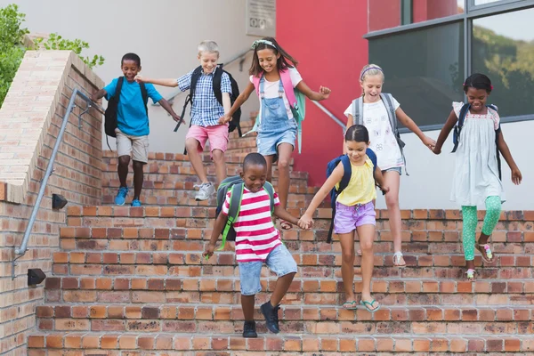 Group of kids getting down from staircase — Stock Photo, Image