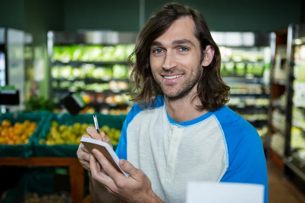 Homem ticking na lista de compras — Fotografia de Stock