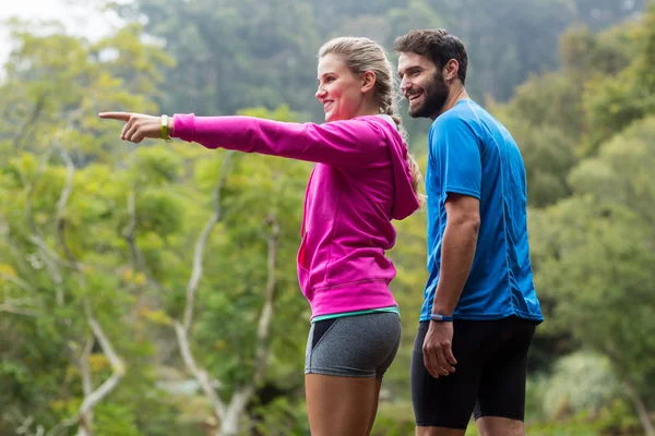 Pareja atlética señalando a la naturaleza —  Fotos de Stock