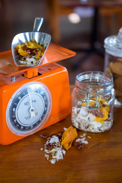 Dried fruits and nuts on weighing machine — Stock Photo, Image