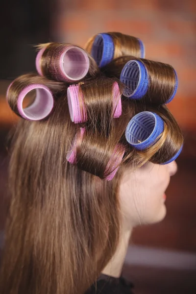 Woman with hair roller on hair — Stock Photo, Image