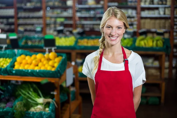 Smiling female staff standing in organic section — Stock Photo, Image
