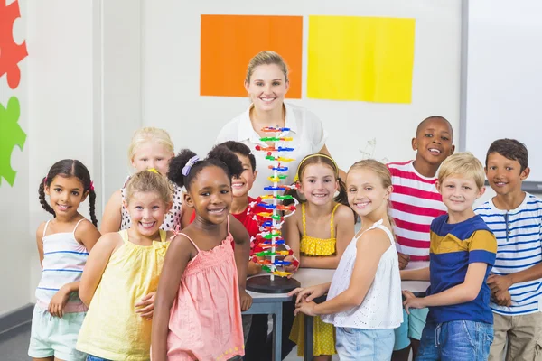 Portrait of kids and teacher standing in laboratory — Stock Photo, Image