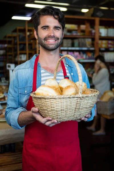 Man holding basket of bread — Stock Photo, Image