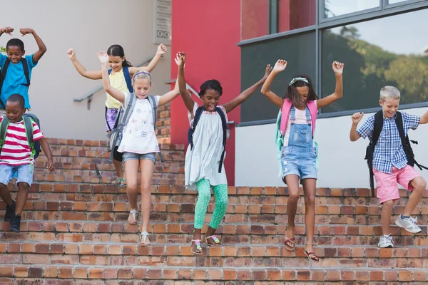 Group of kids getting down from staircase — Stock Photo, Image