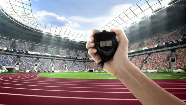 Hand holding stopwatch in olympic stadium — Stock Video